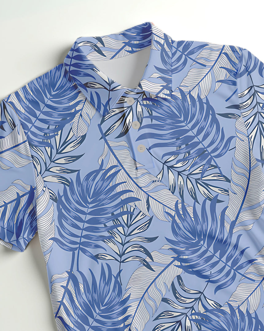 Close up of a blue tropical leaf-patterned golf polo shirt