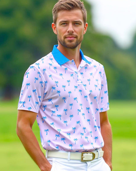 Man wearing a light pink polo shirt with blue palm tree pattern on a golf course