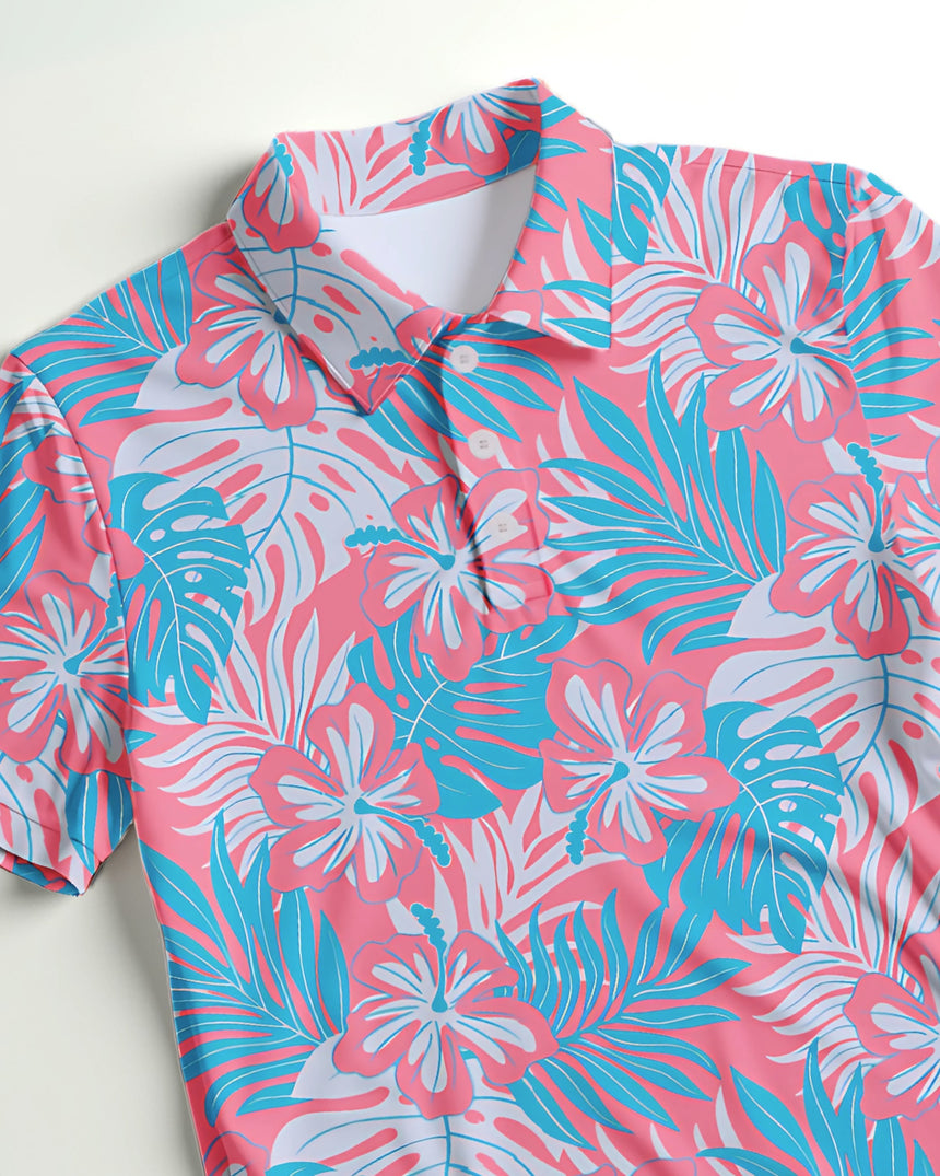 Close up of a pink and blue tropical leaf pattern polo golf shirt