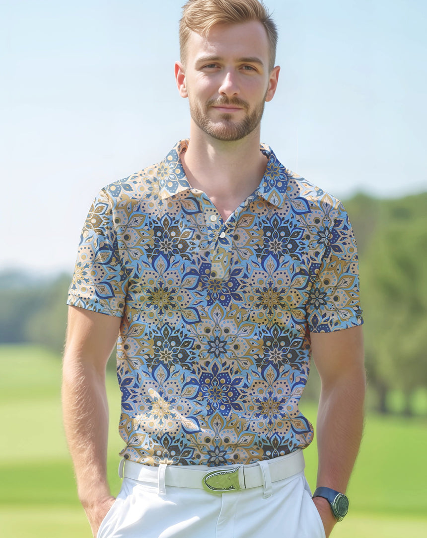 Man standing on a golf course wearing a blue and brown geometric floral print golf polo