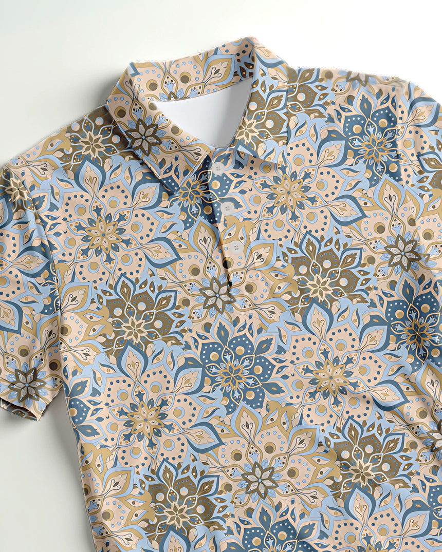 Close-up of a beige and blue floral print golf shirt