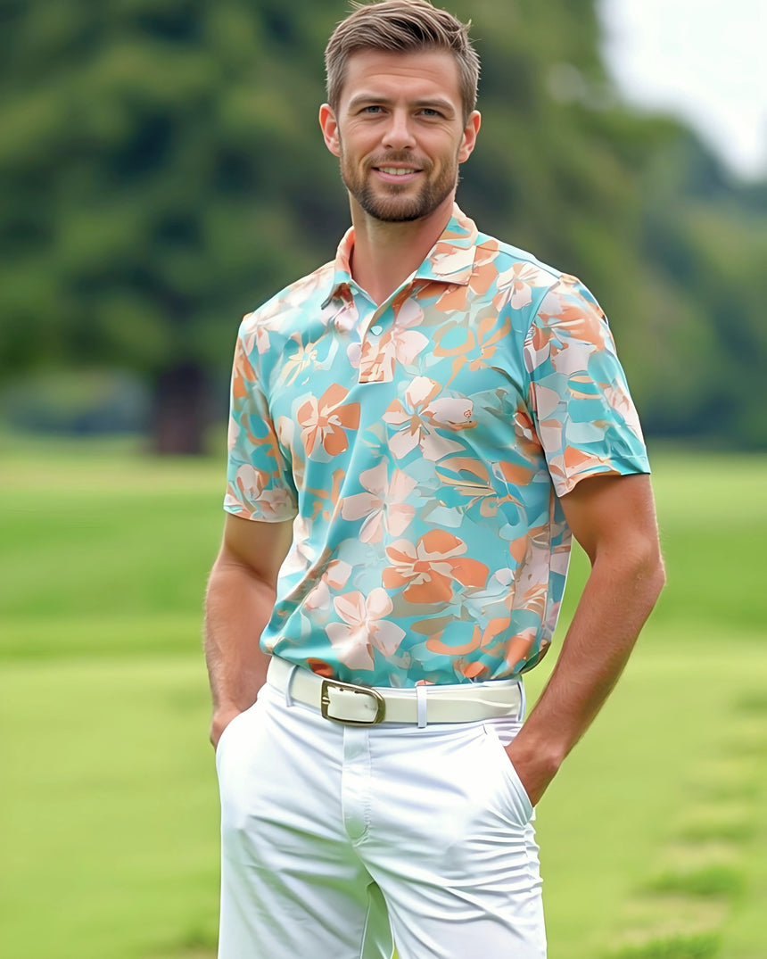 Man wearing a light teal and peach floral print golf polo shirt on a golf course