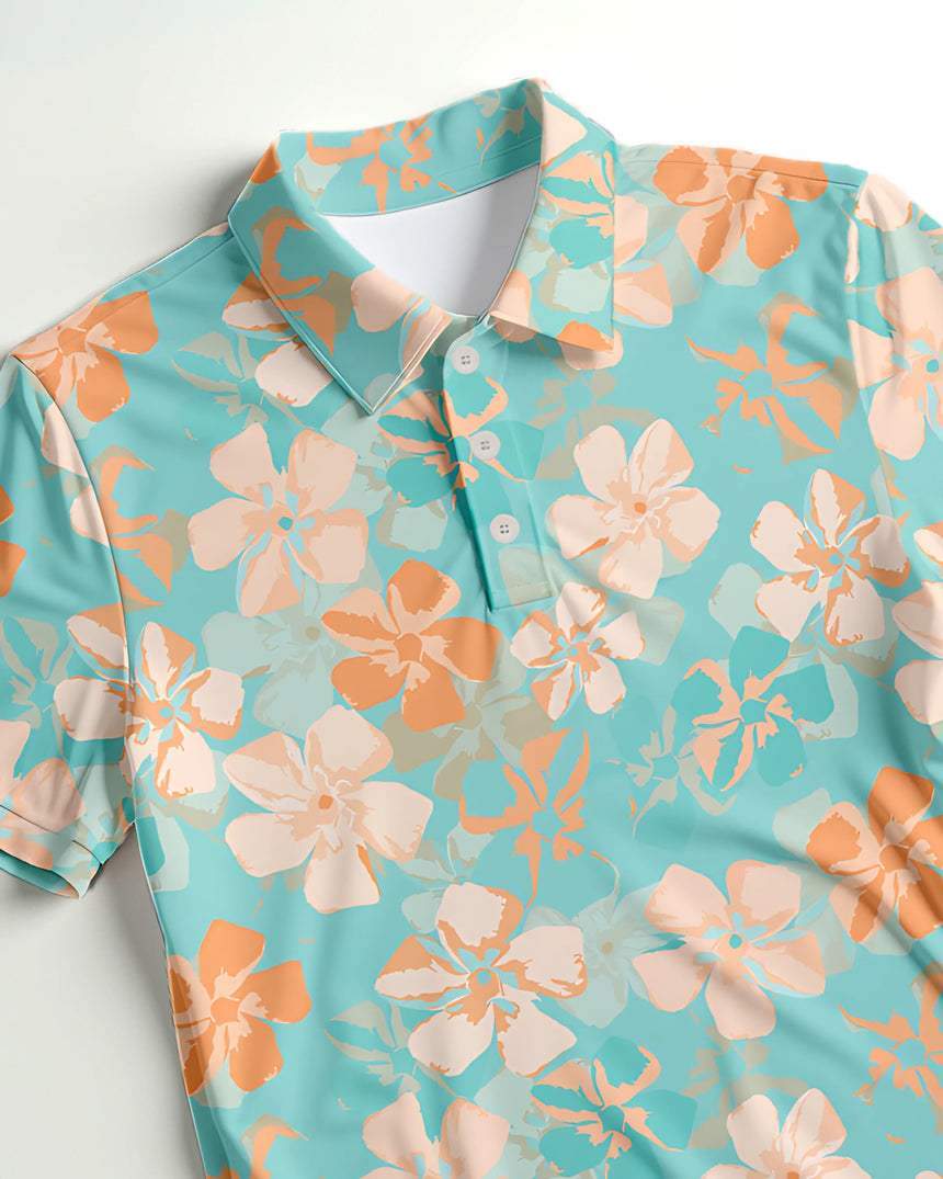 Close-up of a light teal green and peach floral pattern golf polo