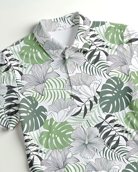 Close up of a golf polo with a green tropical leaf pattern