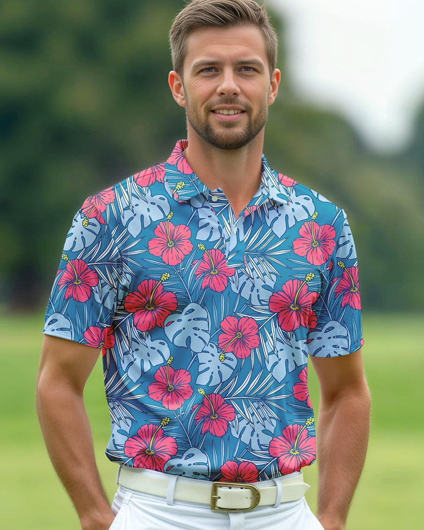 Man wearing a blue floral patterned shirt on a blurred green background