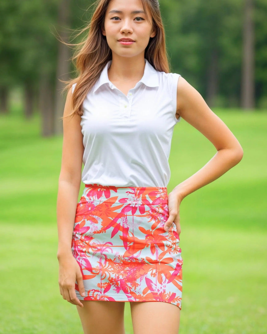 women's fitted golf skort with pockets in Hot Tropic print - model wearing on course
