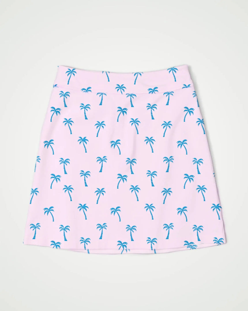 women's fitted golf skort with pockets in Palm Tree Pink print - front view