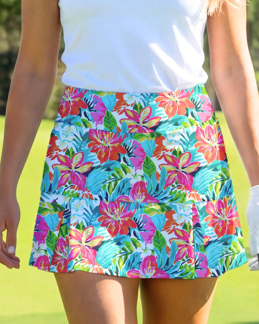 women's pleated golf skort with pockets in Luau Links print - model wearing on course