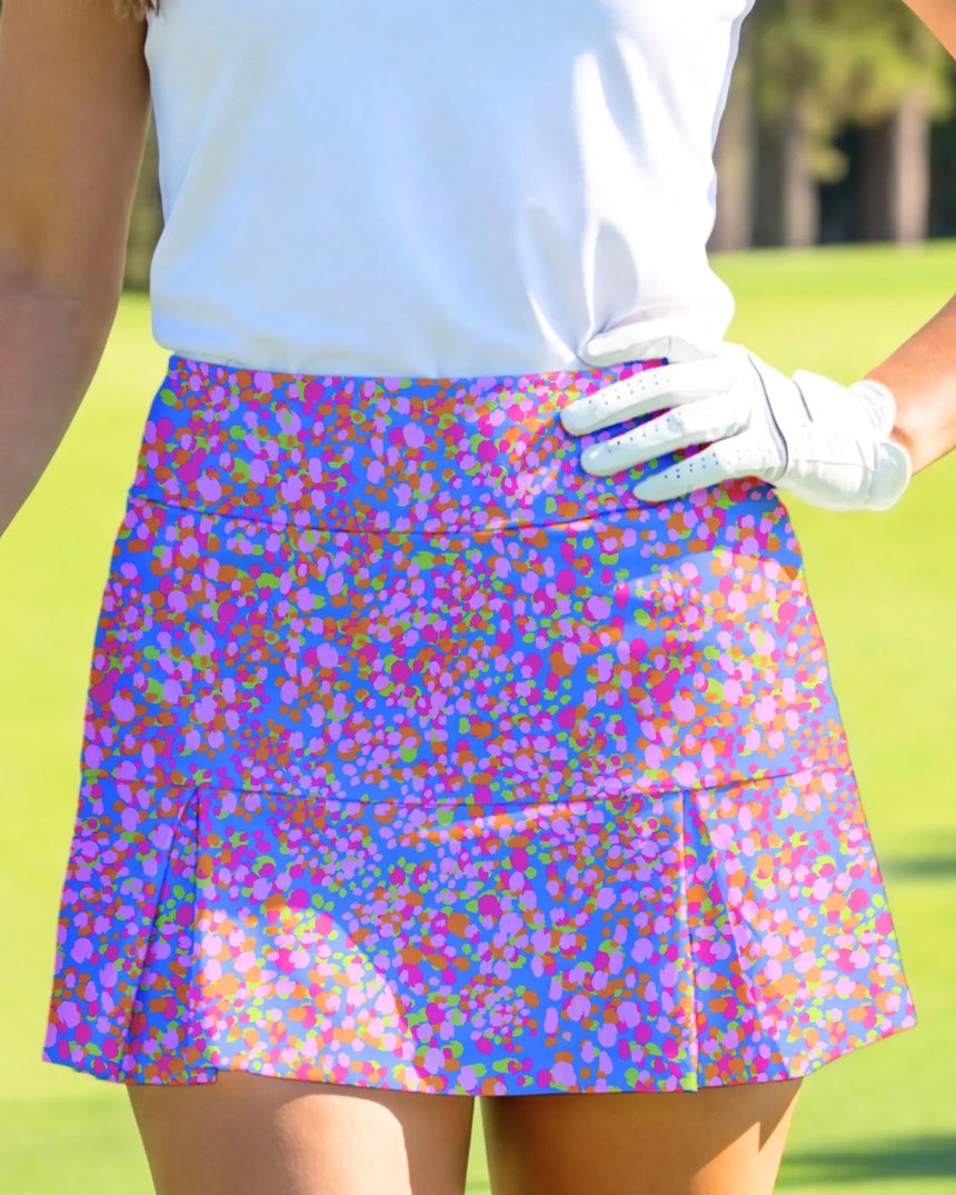 women's pleated golf skort with pockets in Par-tee Confetti print - model wearing on course