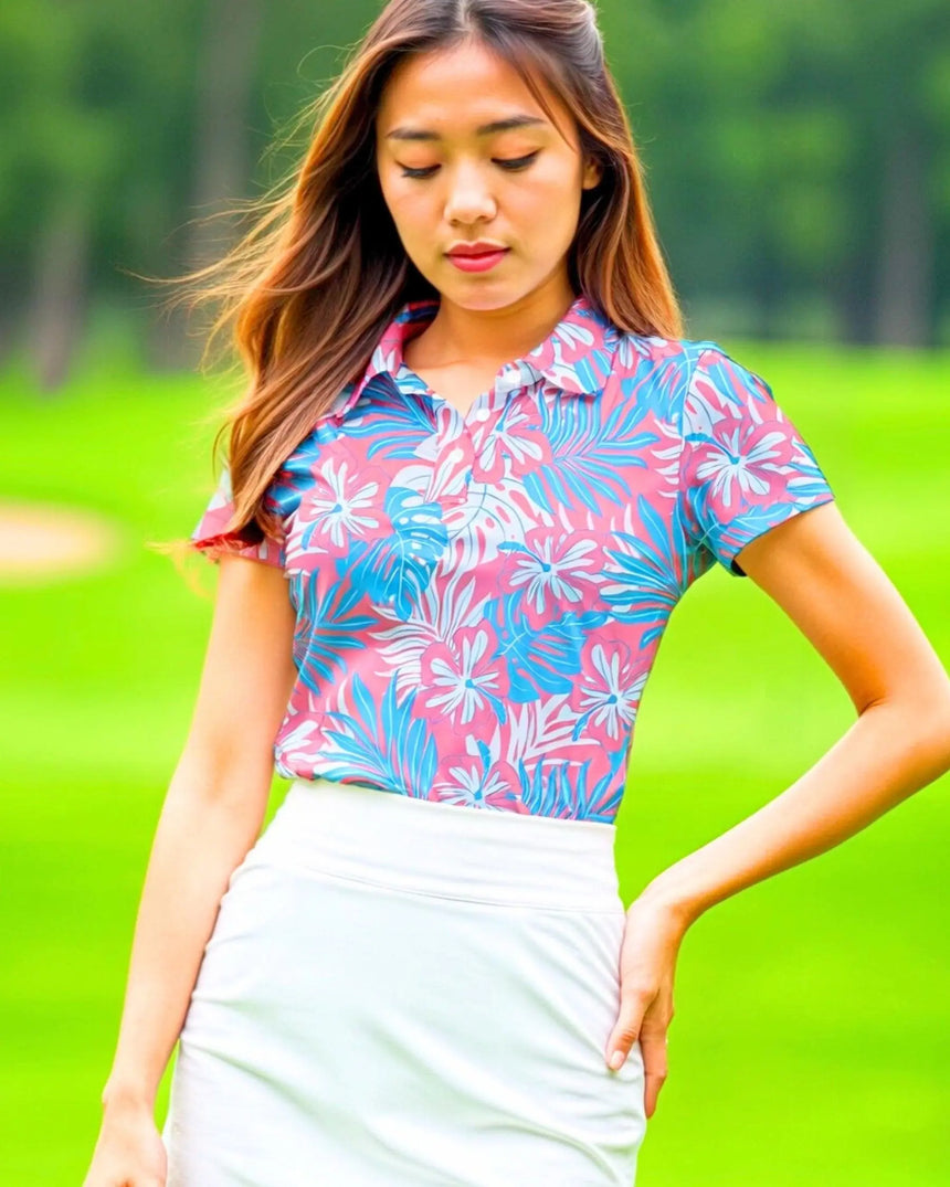 women's short sleeve golf polo in Pink Palms print - model wearing on course