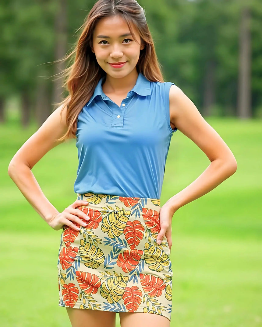 women's sleeveless golf polo in Palm Bay print - model wearing on course