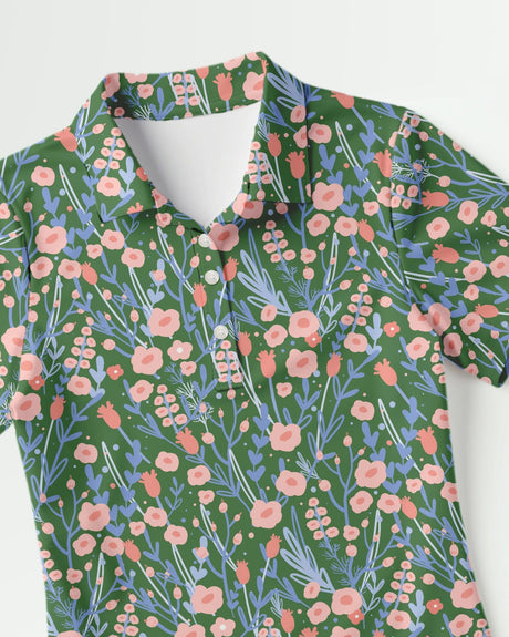 Floral pattern golf shirt with pink and blue flowers on a green background