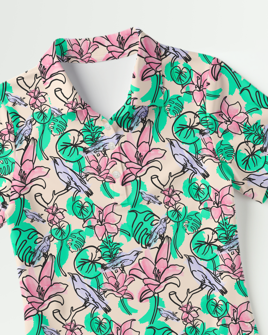 Floral print polo shirt with pink and green flowers and blue birds on a light background