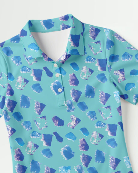 Teal women's polo shirt with blue abstract pattern on a white background