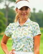 Woman wearing a patterned golf shirt on a golf course