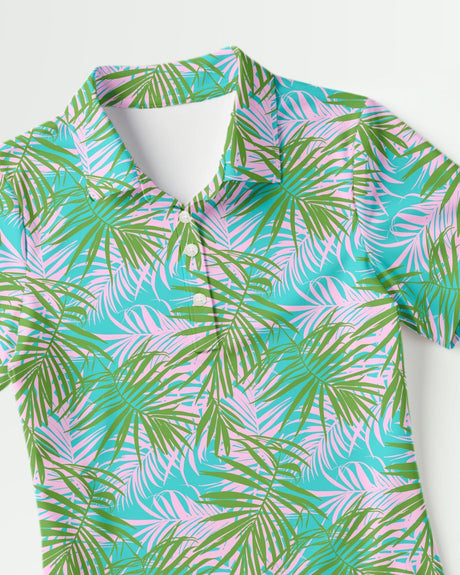 Colorful tropical leaf patterned polo shirt on a white background