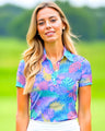 Woman wearing a colorful patterned polo shirt on a golf course