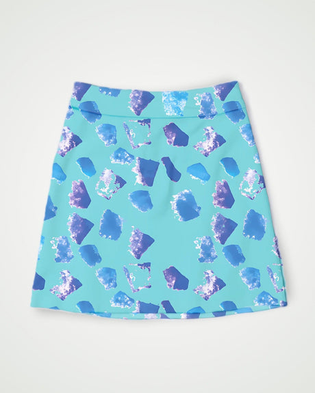 Blue and purple patterned golf skirt on a light gray background