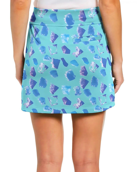 Blue patterned golf skirt worn by a girl on a white background