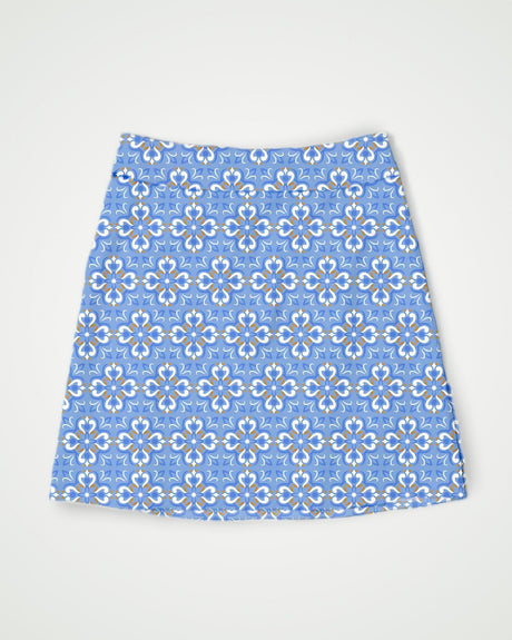 Blue floral print golf skort on a light gray background
