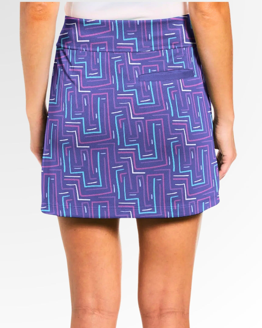 Purple and blue patterned skirt worn by a person on a white background