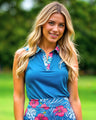 Woman wearing a blue floral golf outfit on a green outdoor background