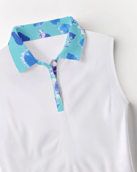 White sleeveless golf polo with a colorful pattern collar on a light gray background