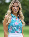 Woman wearing a floral sleeveless golf shirt with a blurred green background