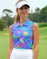 Woman wearing a colorful sleeveless golf top on a golf course