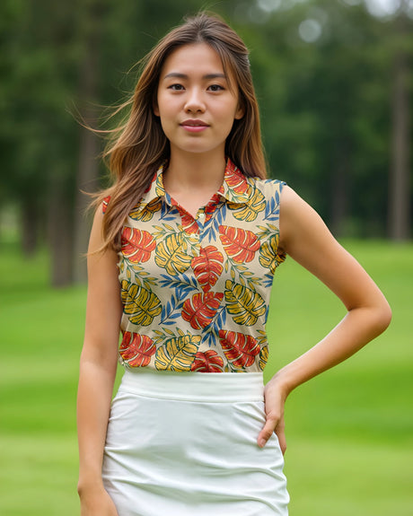 Woman wearing a colorful sleeveless top with leaf pattern on a grassy background