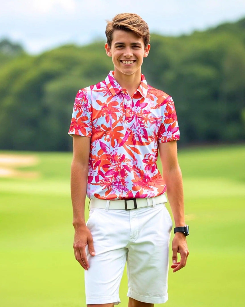 youth short sleeve golf polo in Hot Tropic print - model wearing on course
