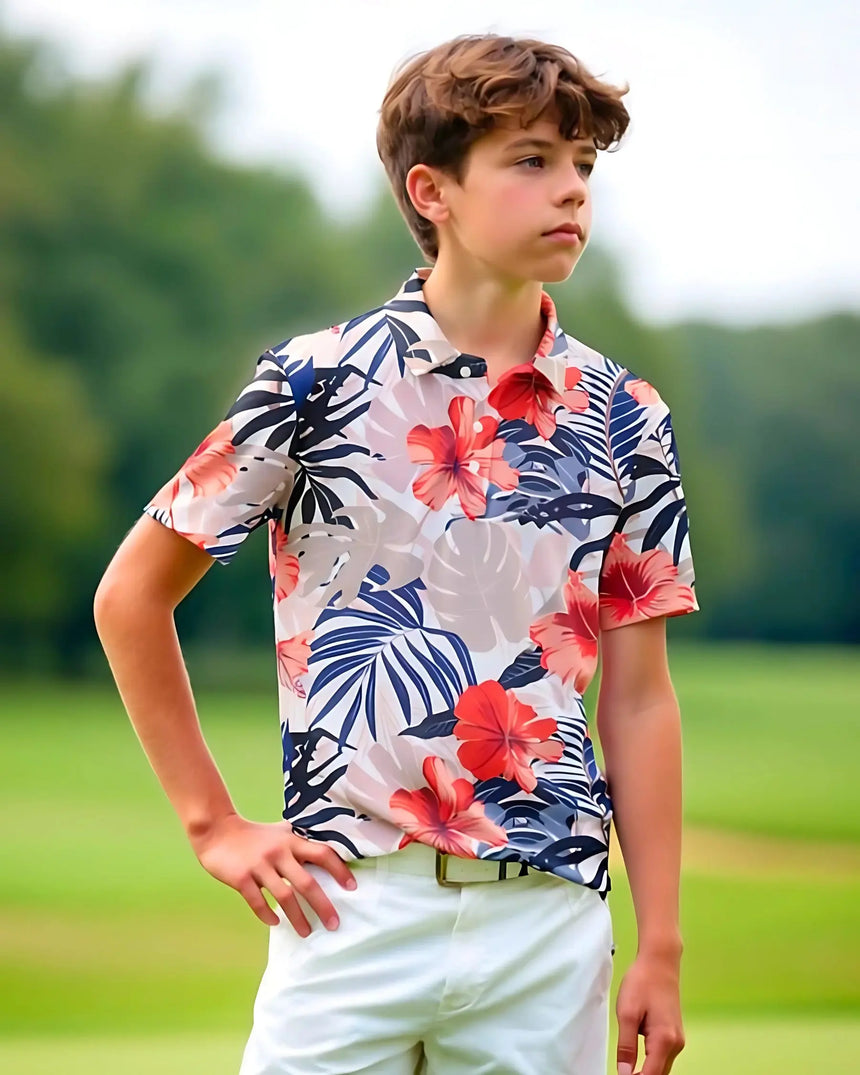 youth short sleeve golf polo in Island Floral print - model wearing on course