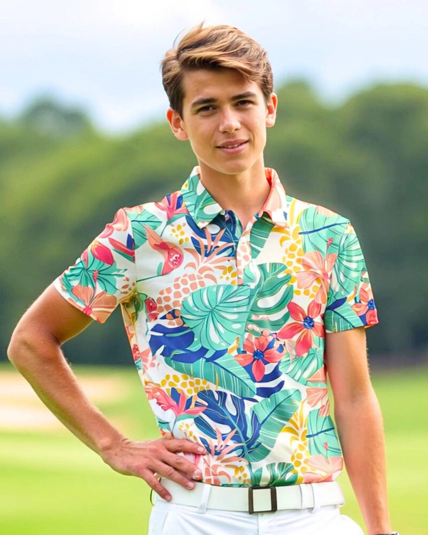 youth short sleeve golf polo in Tee Time Tropic print - model wearing on course