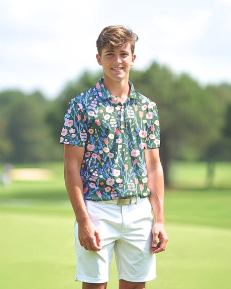 Youth wearing a colorful floral golf polo and white shorts on a golf course
