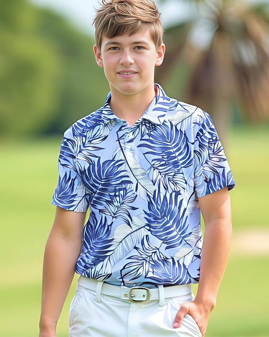 Young boy wearing a blue and white patterned shirt outdoors
