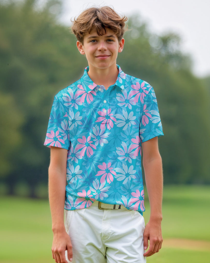 Young boy wearing a blue and pink floral polo shirt on a golf course