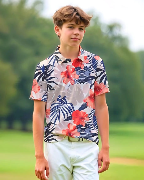 Young boy wearing a floral polo shirt with a blurred green background