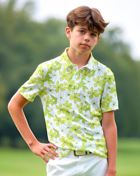 Young boy wearing a green and white floral golf polo shirt outdoors